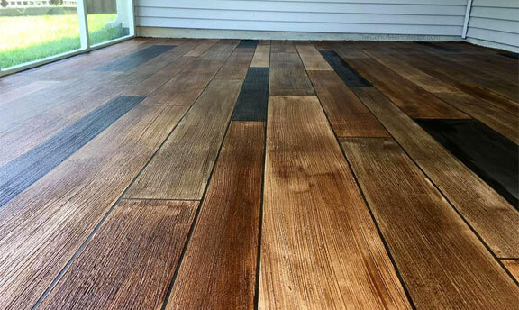 Reduced Maintenance This image shows a floor that has a wood Stamped Concrete Flooring.