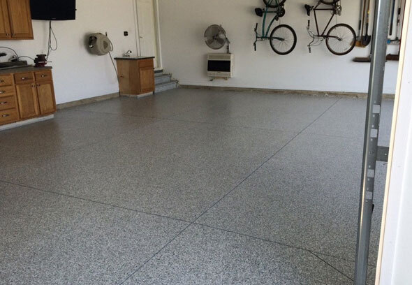 This image shows a garage floor with flake epoxy painted floor.