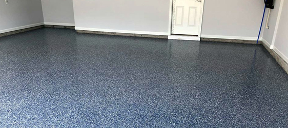 This image shows a garage floor with flake epoxy painted floor.