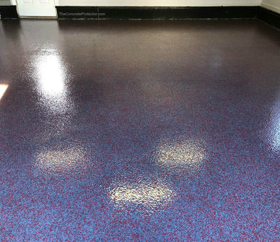 This image shows a garage floor with flake epoxy painted floor.