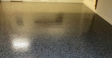 Epoxy Flooring This image shows a garage floor with flake epoxy painted floor.