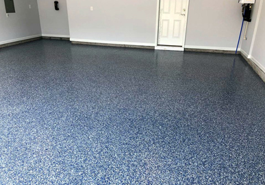 This image shows a garage floor with flake epoxy painted floor.
