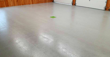 This image shows a garage floor with flake epoxy painted floor.