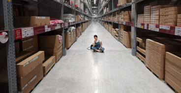aesthetically-pleasing This image shows a woman sitting in a warehouse with a polished concrete floor.