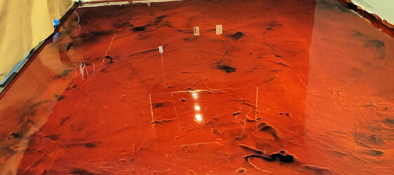 Garage-Epoxy-Coating This image shows a metallic epoxy floor that is very shiny. The floor's color is red.