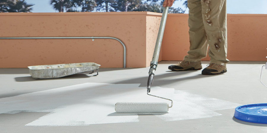 nampa-epoxy-coating This image shows a man applying epoxy paint on the floor.