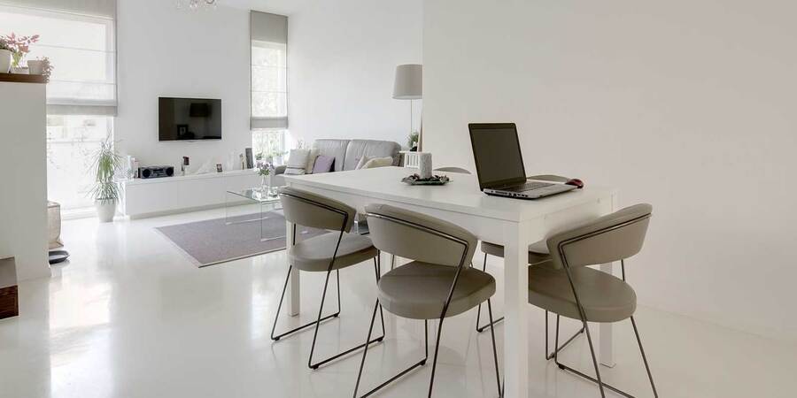 residential-epoxy-floor-coating-nampa This image shows a dining and living room with an epoxy-painted floor.
