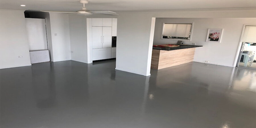 residential-epoxy-coating This image shows a living room with gray epoxy floor.